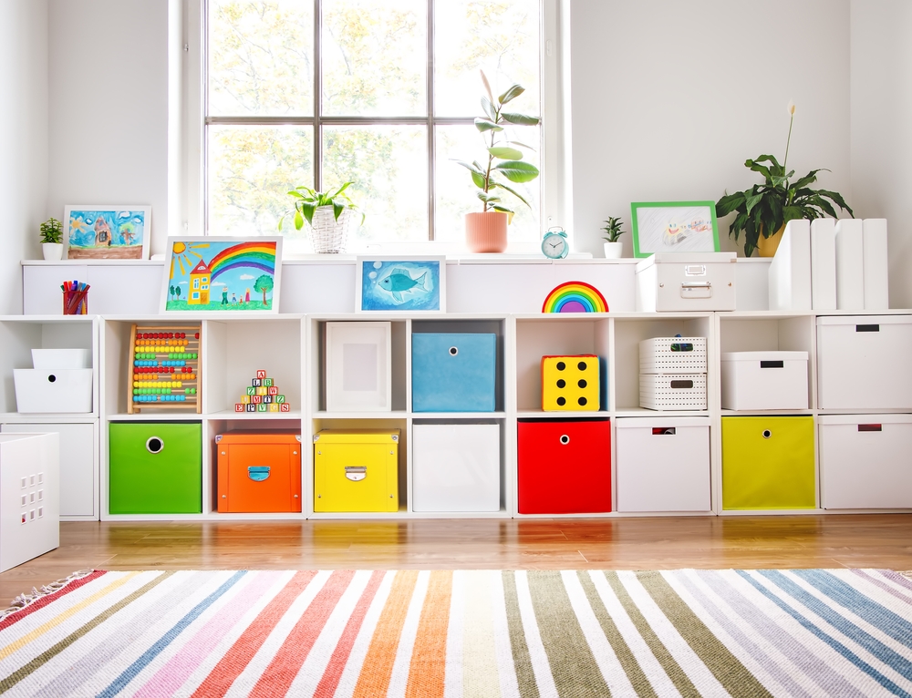 White,Nursery,Room,With,Shelves,And,Colourful,Boxes.